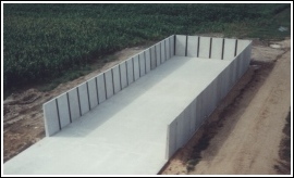 Concrete storage structure in open field.