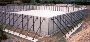 Concrete structure with angled metal supports.